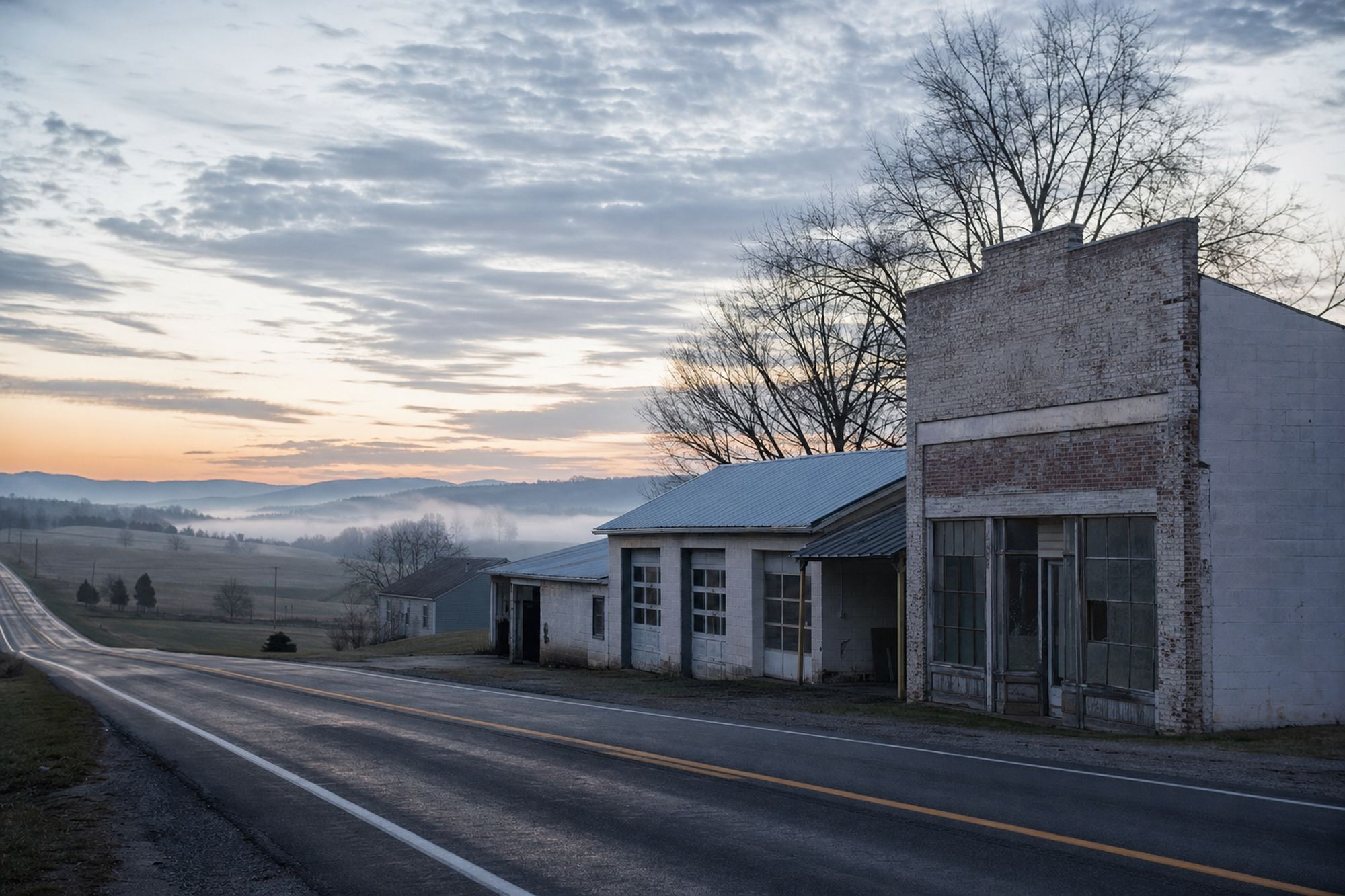A quiet rural Virginia highway at dawn with an empty roadside shop building